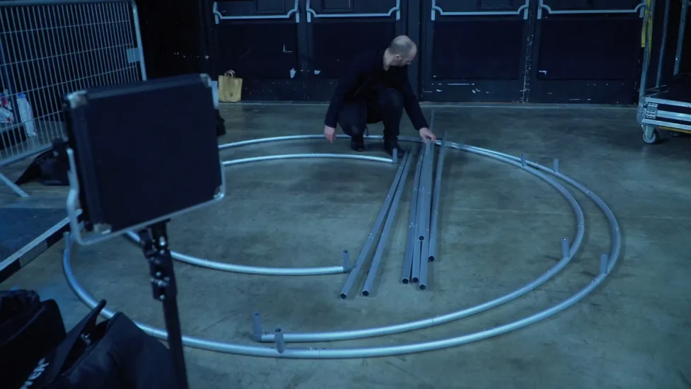 Technicien de Catchingbox assemblant un photocall en métal au stade Paris la Défense Arena pour le Racing 92